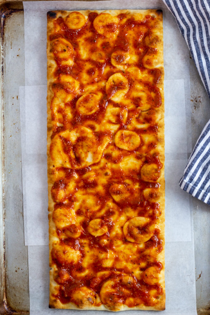 Tomato sauce on top of a store-bought crust.