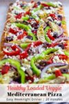 Loaded veggie Mediterranean pizza before baking in the oven.