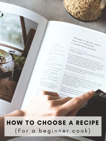 A person about to flip a page in a cookbook.