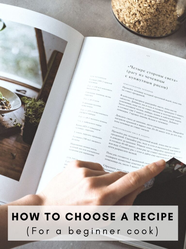 A person about to flip a page in a cookbook. 