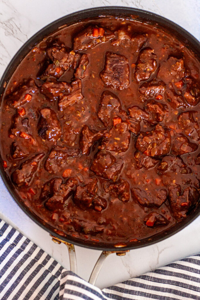 Take the lid off the pan and reduce the sauce until it reaches its desired thickness.