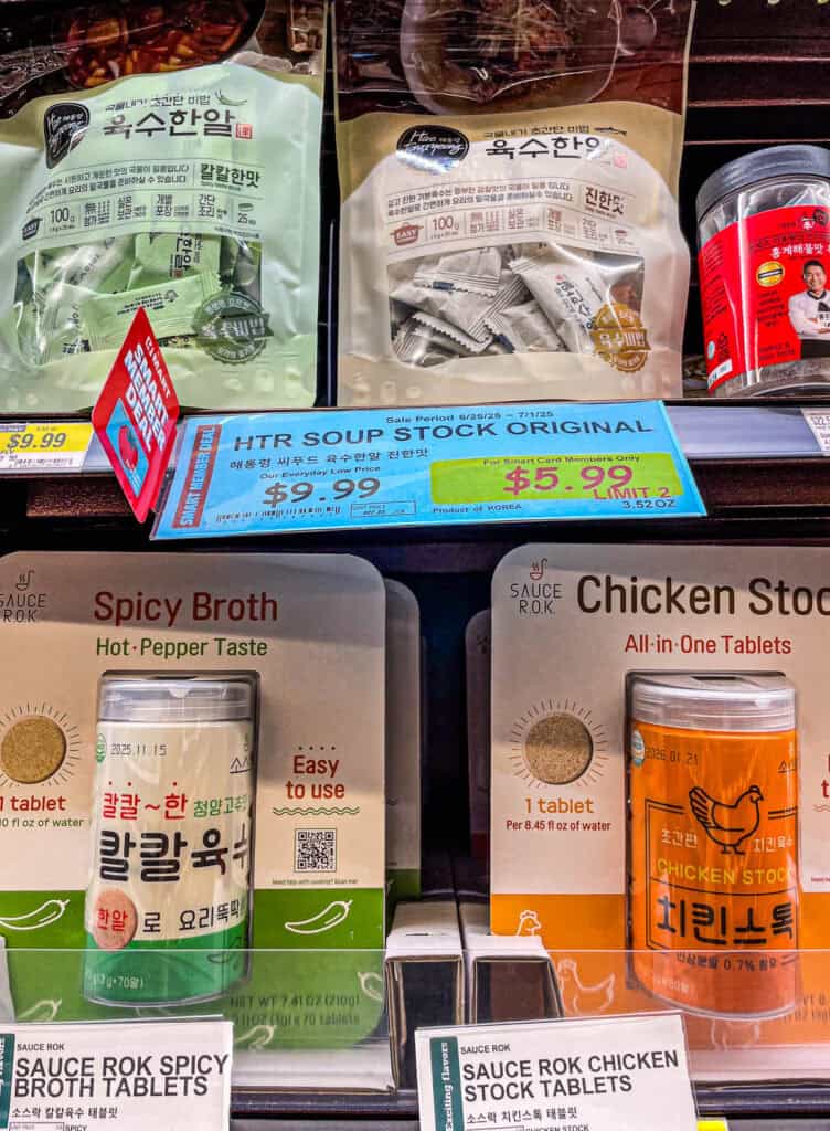 Soup coin packages for anchovy and original flavors, shown on a shelf with a sale sign