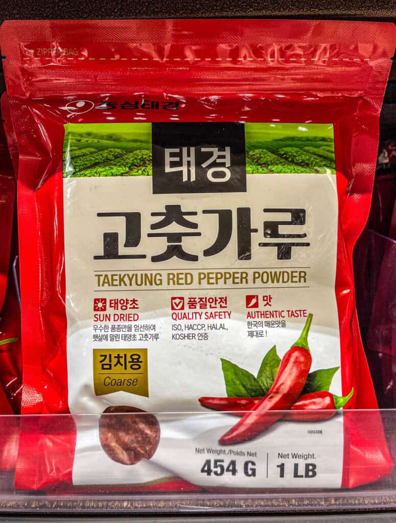 A package of Taekyung coarse red pepper powder (gochugaru) labeled for kimchi use, featuring sun-dried peppers and quality certifications