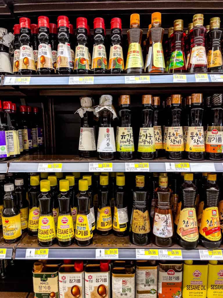 Various Korean sesame oil brands on display at HMart, including Ottogi, Sempio, and Chung Jung One