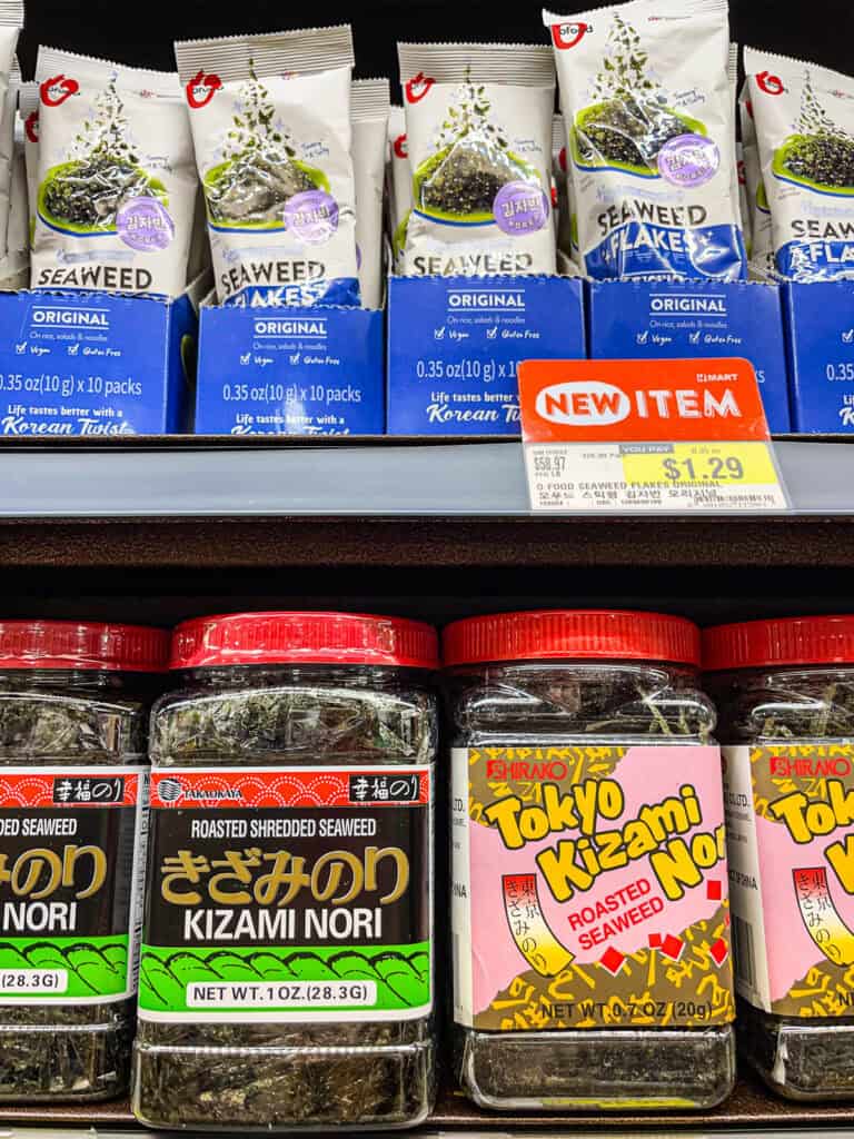 Jars of roasted shredded kizami nori and packs of seaweed flakes, both popular Japanese seaweed toppings for rice, noodles, and salads.