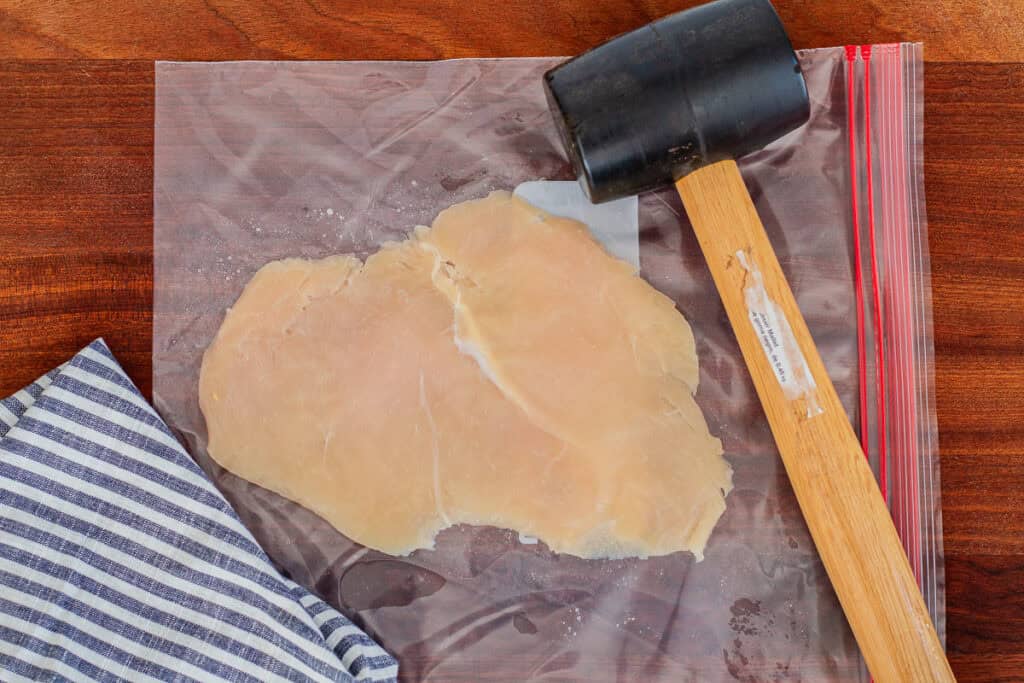 Flattened chicken breast after pounding with a mallet, ready to stuff for chicken roulade.