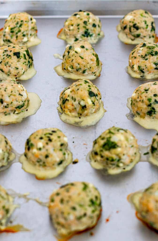 Moist Greek chicken meatballs with feta and spinach baked on a sheet pan
