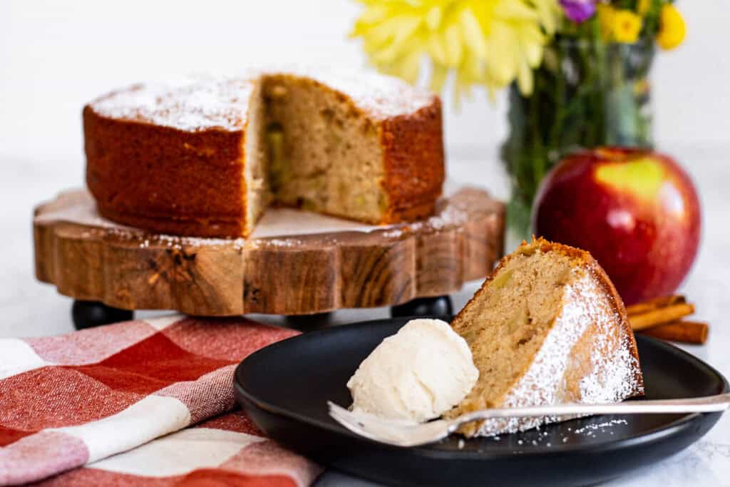 Slice of mini spiced apple cake served with a scoop of vanilla ice cream for a cozy fall dessert