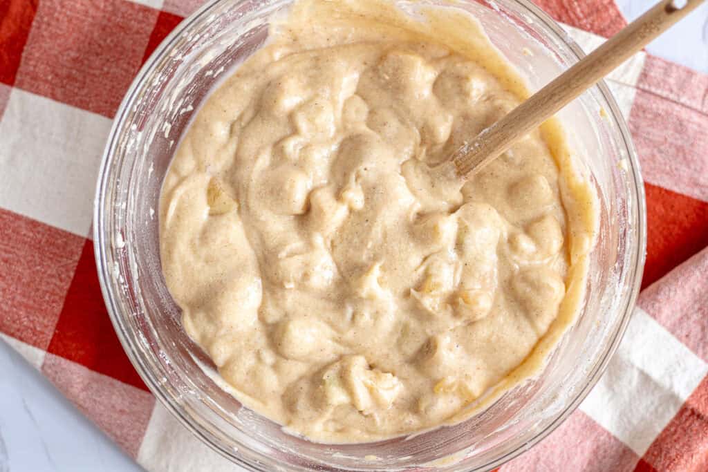 Apple and flour mixture folded into spiced cake batter for cozy fall apple cake