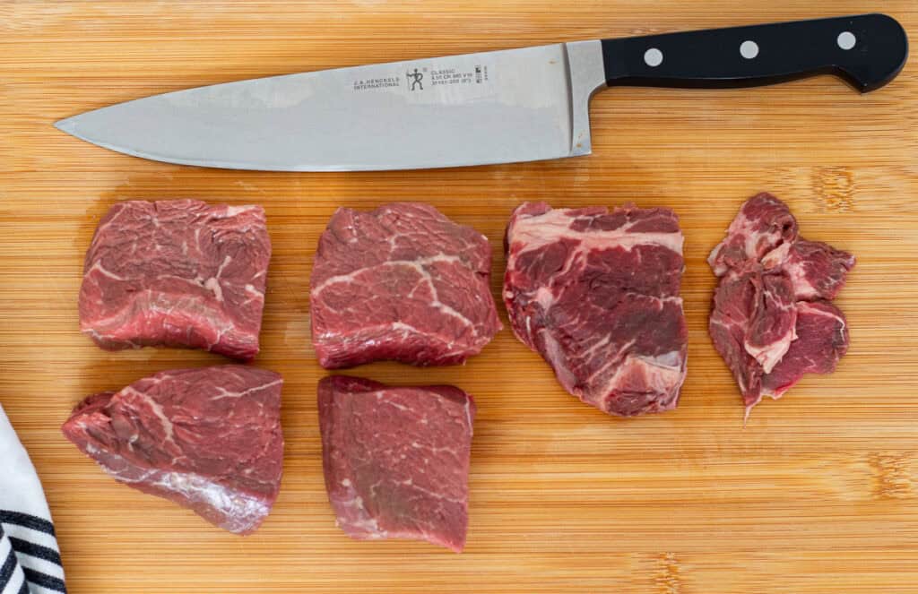 Beef sliced into thin strips on a cutting board, ready for a tender beef and broccoli stir fry.