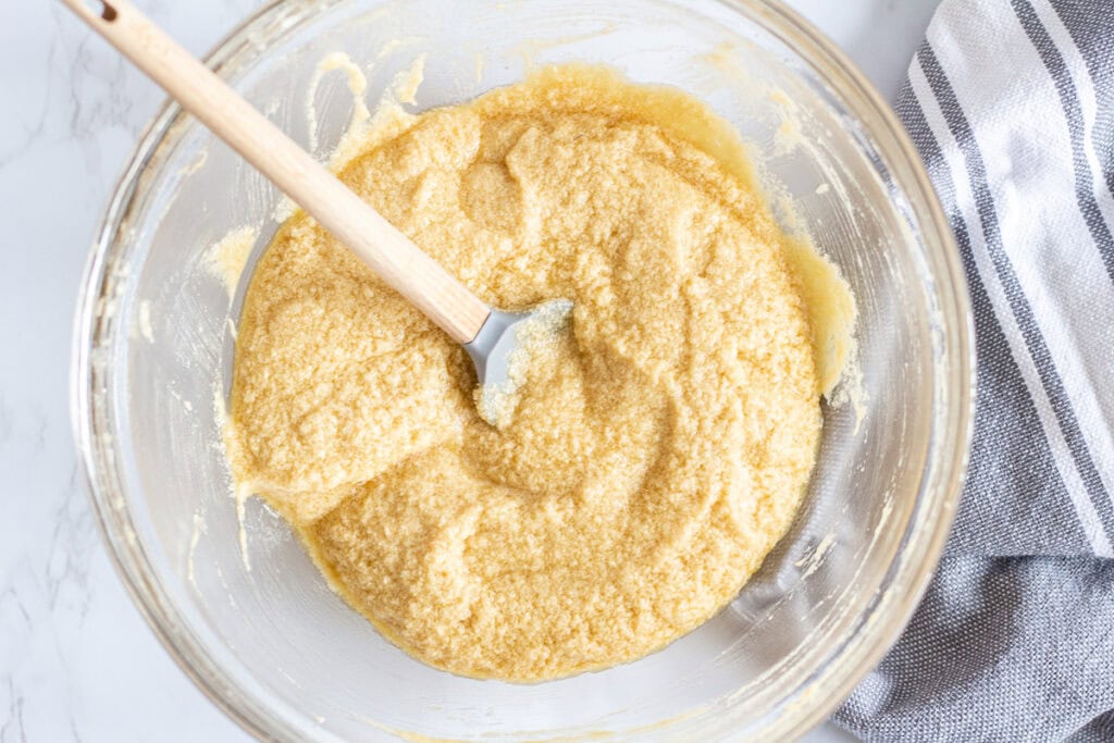 Butter, brown sugar, and eggs mixed together for sticky toffee pudding recipe