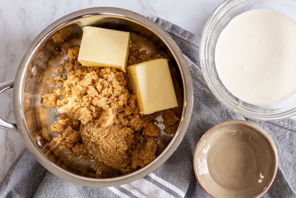 Butter, brown sugar, cream, and corn syrup ingredients for toffee sauce in sticky toffee pudding recipe