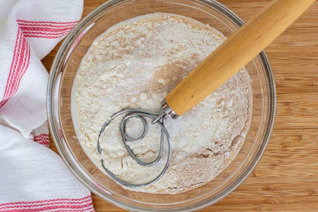 Bread flour and whole wheat flour added to the starter mixture before stirring