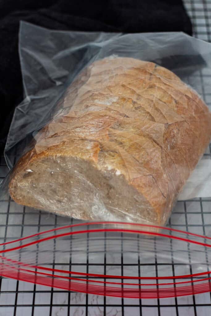 Sliced sourdough discard bread wrapped and placed in a freezer-safe bag for long-term storage.