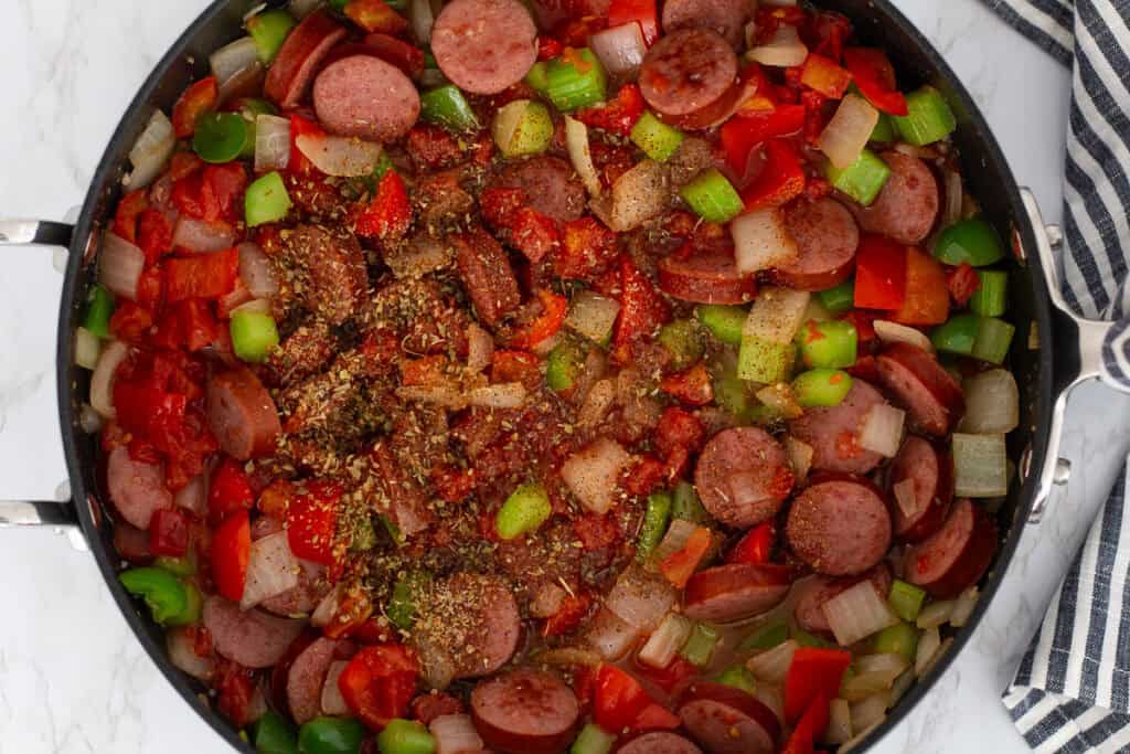 Seasonings added to sautéed sausage, onions, peppers, and celery for Cajun sausage and shrimp stew.