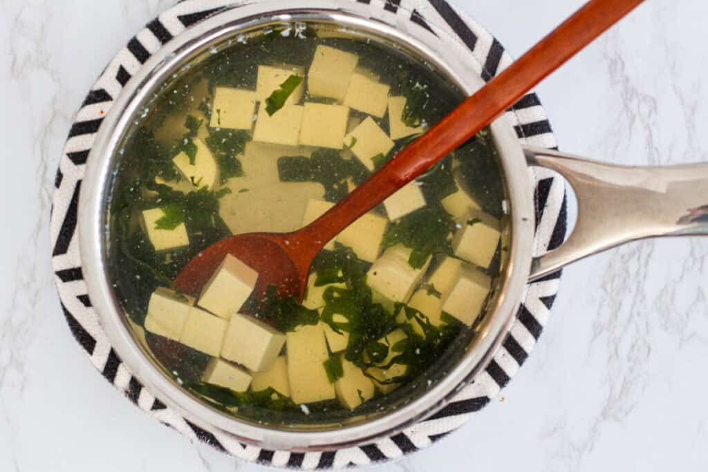 Silken tofu and wakame seaweed simmering in dashi