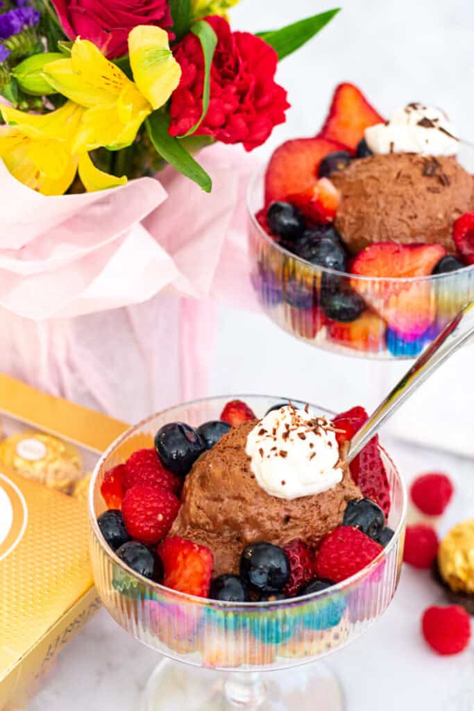 3 ingredient chocolate mousse topped with whipped cream and fresh berries