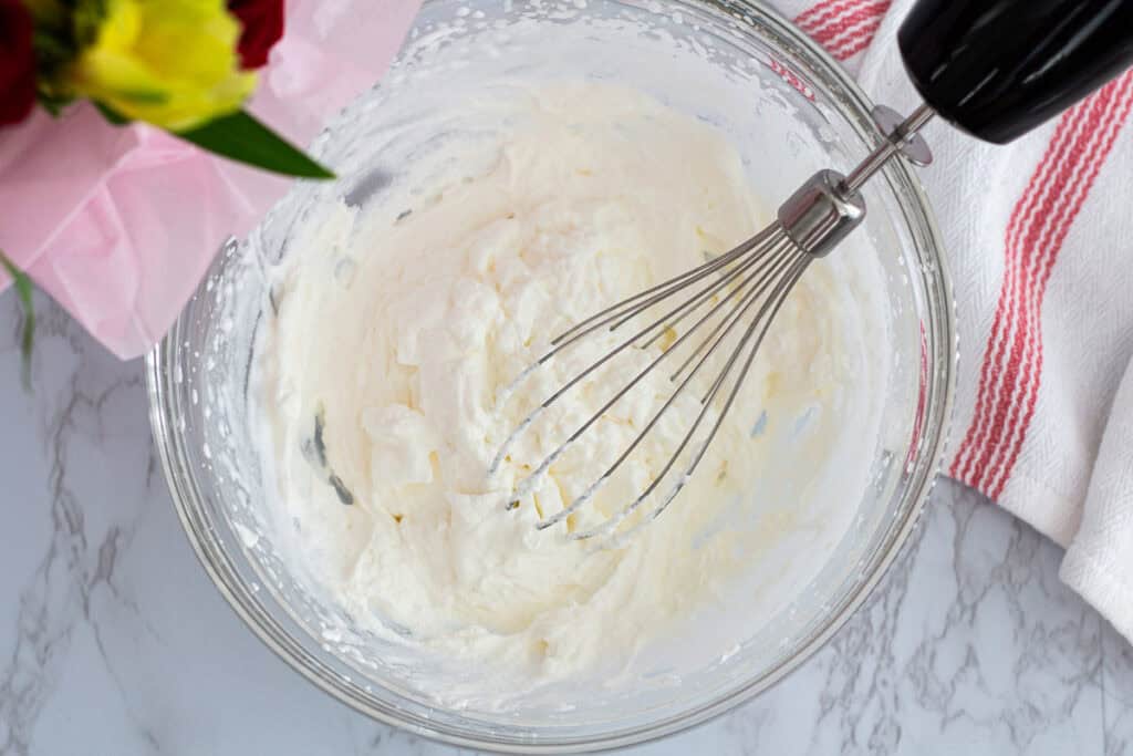 Heavy cream whipped to medium peaks for making chocolate mousse