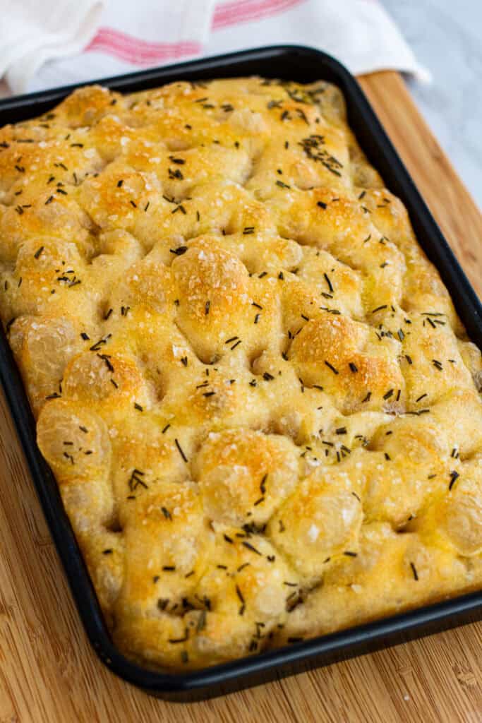 Golden sourdough discard focaccia with crisp edges and flaky salt