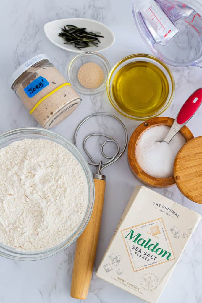 Ingredients for sourdough discard focaccia including flour, discard, olive oil, yeast, and salt