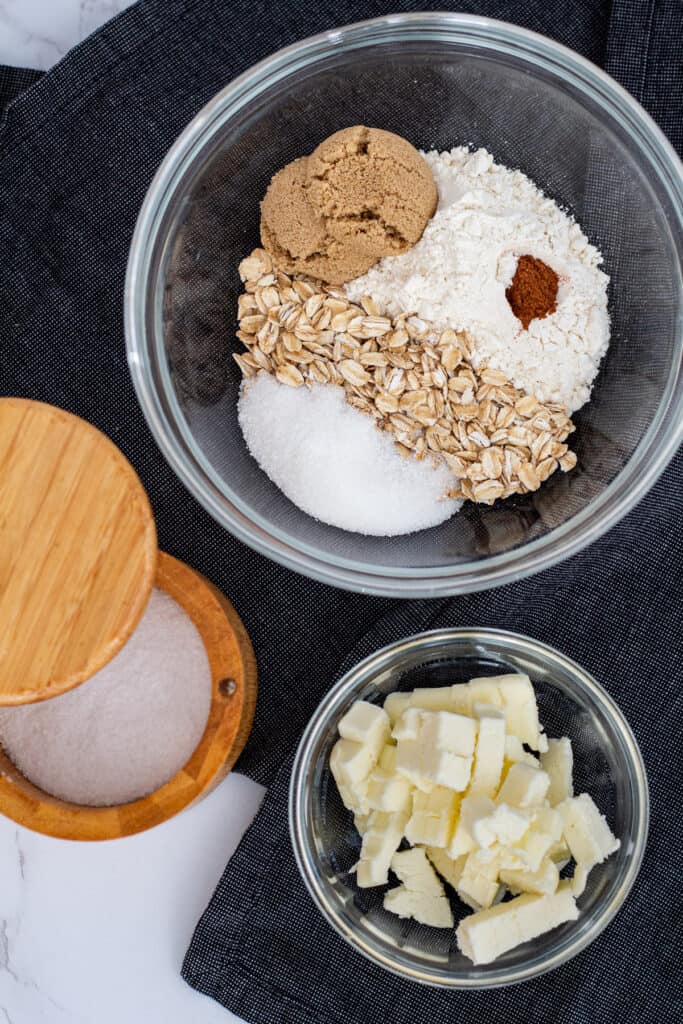 Ingredients for cherry crisp topping including oats, flour, brown sugar, butter, and cinnamon in a bowl