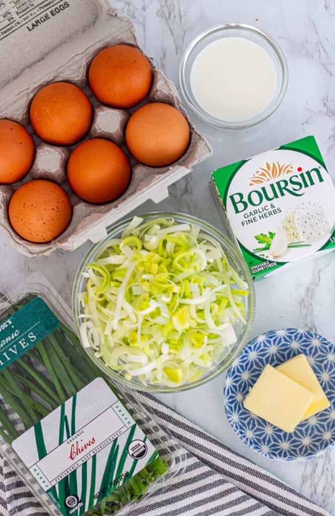 Eggs, sliced leeks, milk, butter, chives, and Boursin cheese for leek frittata.