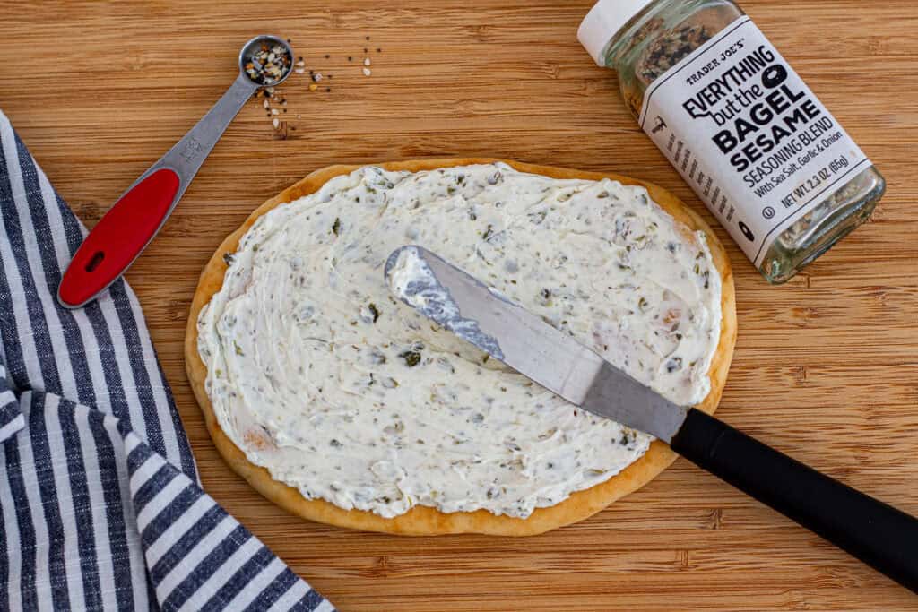 Flatbread spread with whipped cream cheese and capers before adding toppings.