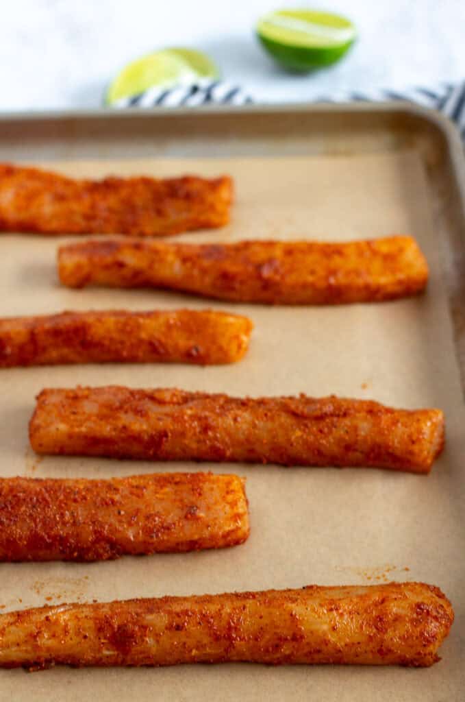 Seasoned mahi mahi fillets arranged on a sheet pan before cooking for blackened fish tacos.
