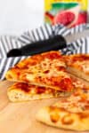 Slice of homemade cheese pizza made with sourdough discard pizza dough