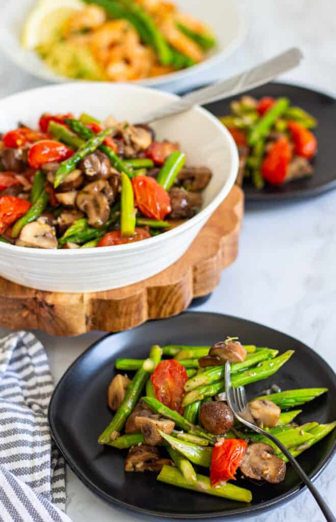 Roasted asparagus salad with mushrooms and tomatoes served as a spring side dish