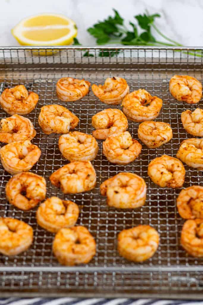 Cooked shrimp resting on a rack after air frying