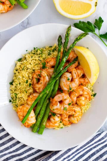 Close-up of shrimp and couscous with lemon and herbs