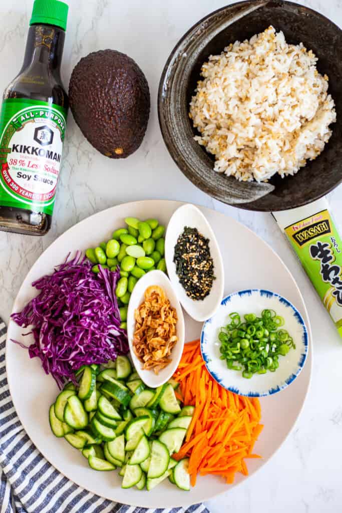 rice, vegetables, and toppings prepared for shrimp poke bowl