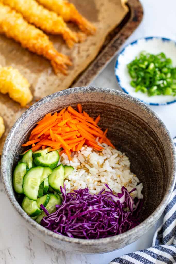 shrimp poke bowl base with rice, cucumber, cabbage, and carrots