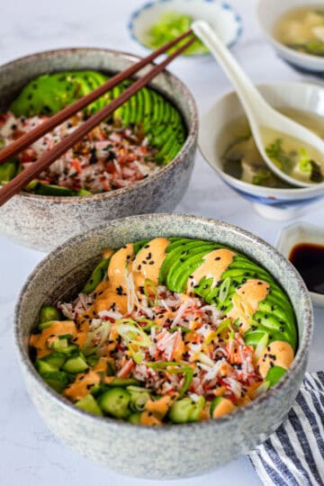 Two California Roll Bowls served with easy miso soup, soy sauce, and wasabi for a simple sushi-inspired meal at home.