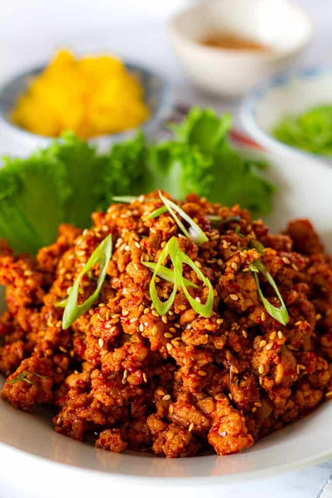 Close-up of sweet, savory, and spicy gochujang ground pork garnished with green onions and sesame seeds.