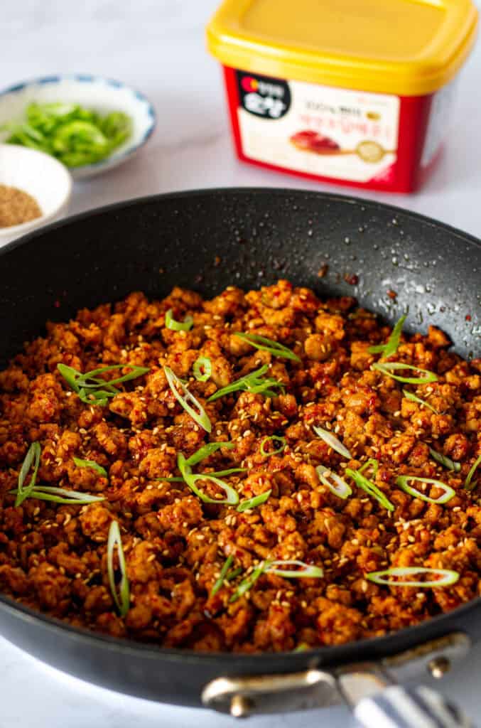 Gochujang ground pork coated in a glossy spicy sauce and finished with green onions and sesame seeds.