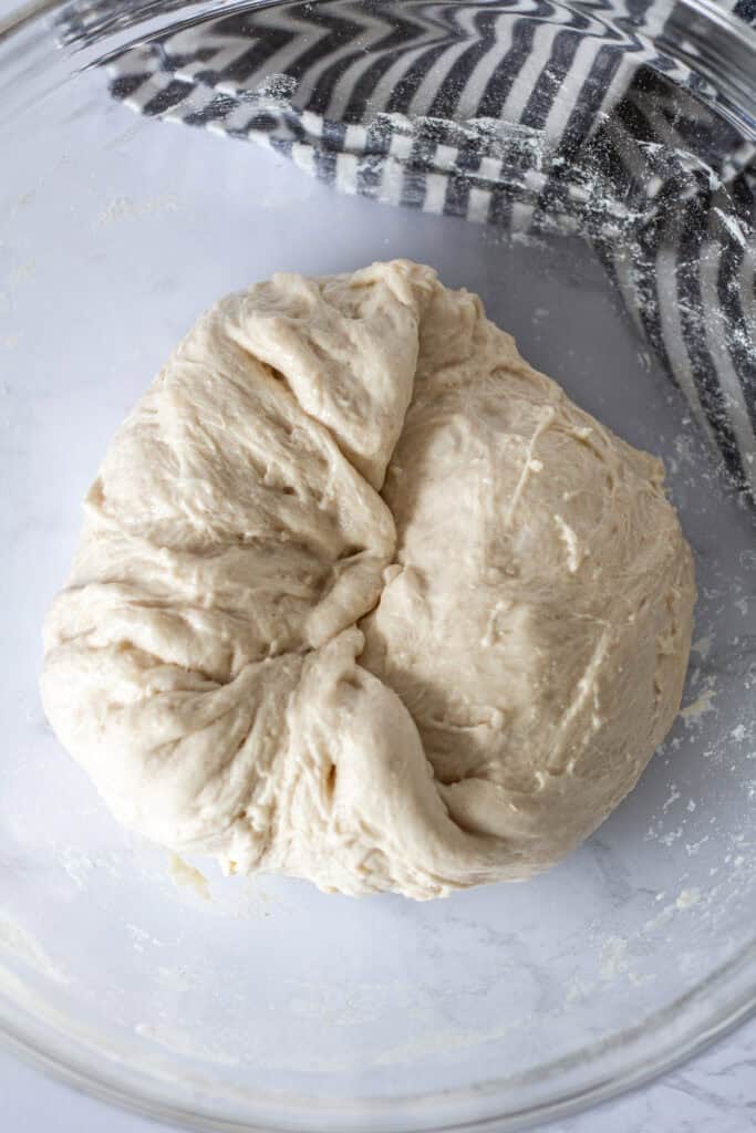 Performing a bowl fold to strengthen sticky pizza dough