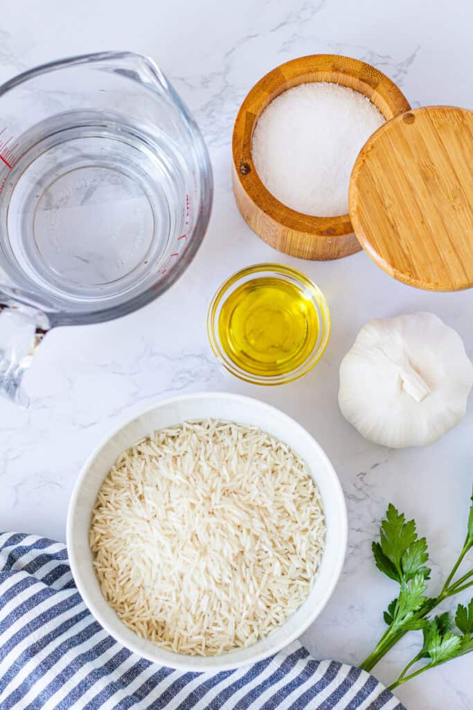 Ingredients for garlic basmati rice including basmati rice, garlic, olive oil, water, and salt