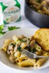 Creamy Boursin chicken pasta with mushrooms and spinach served with garlic bread