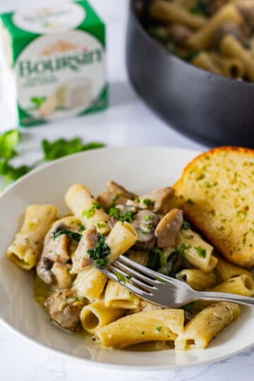 Creamy Boursin chicken pasta with mushrooms and spinach served with garlic bread