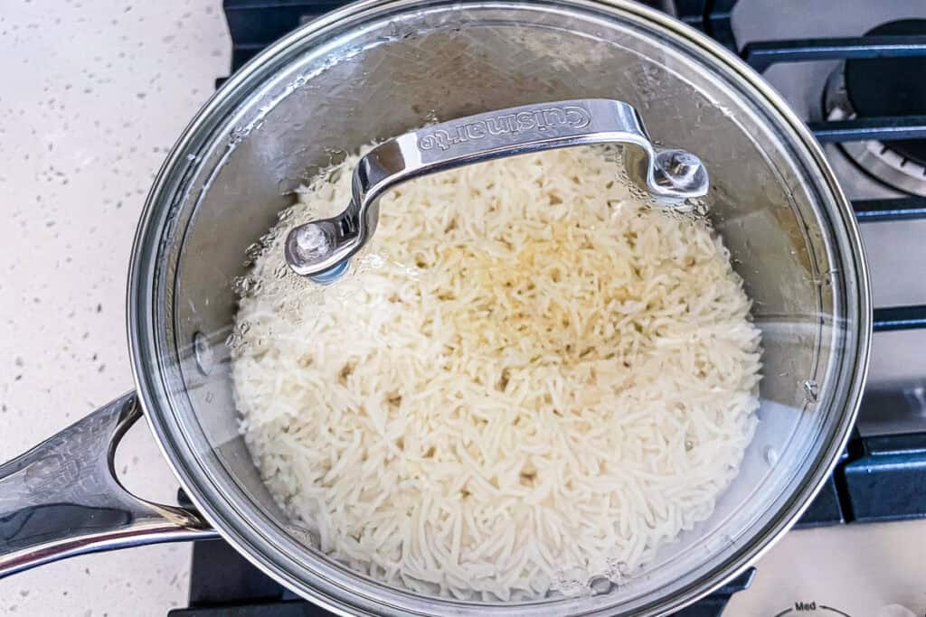 Cooked garlic basmati rice after simmering and before fluffing