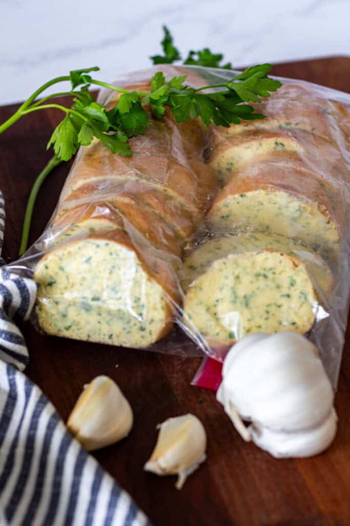 Frozen garlic bread slices packed in a freezer bag for make-ahead storage