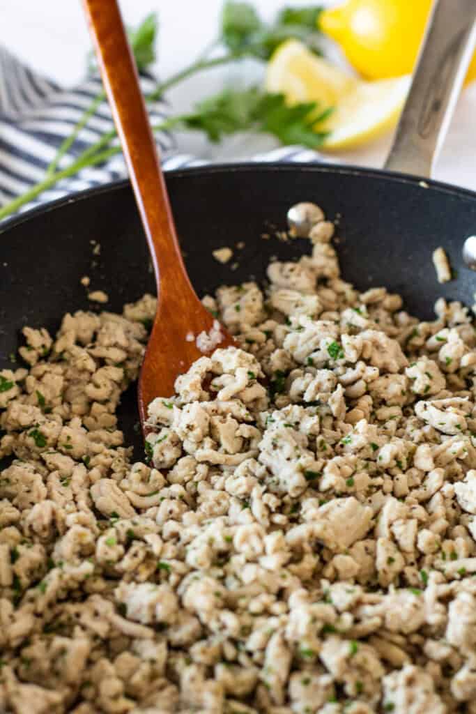 Cooked Greek-style ground turkey seasoned with garlic, oregano, lemon pepper, and fresh parsley.