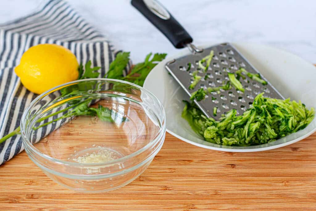 Garlic mixed with lemon juice and grated Persian cucumber for homemade tzatziki sauce