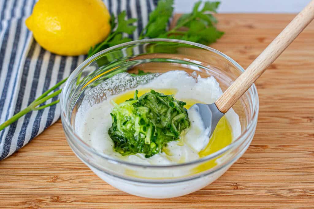 Adding grated cucumber to Greek yogurt for small batch tzatziki sauce