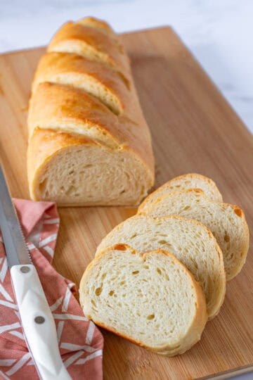 Sliced sourdough discard French bread showing its soft, tender crumb and golden crust.