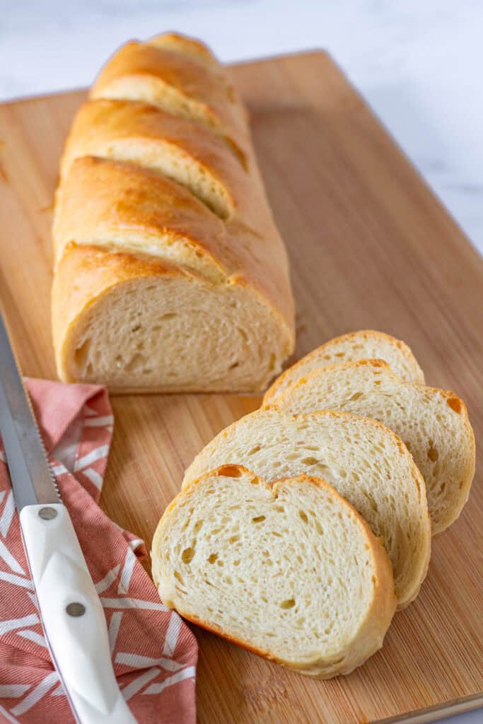 Sliced sourdough discard French bread showing its soft, tender crumb and golden crust.