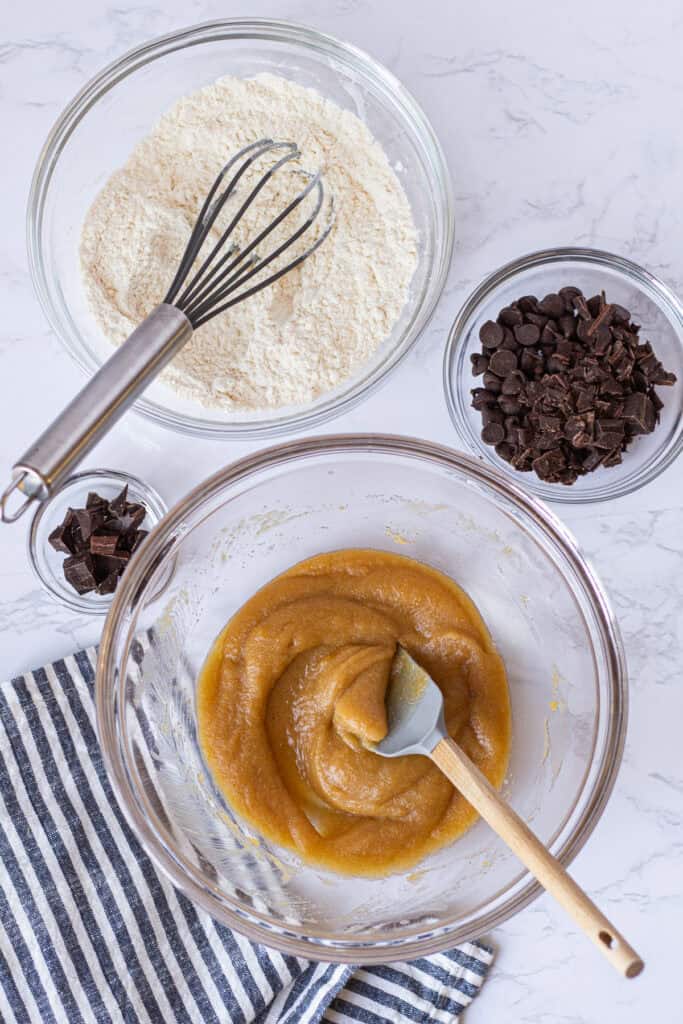 Wet ingredients in a mixing bowl with dry ingredients and chopped chocolate ready to be added